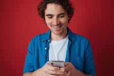 Young adult man using a non ai language learning app on his smartphone