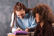 Happy-student-and-tutor-in-a-private-tutoring-lesson