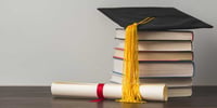 university cap and pile of books