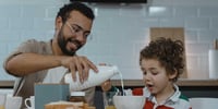 father and son having breakfast together