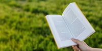 hand holding a book outside