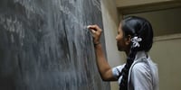 girl writing on board
