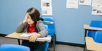 child sitting at a desk in class