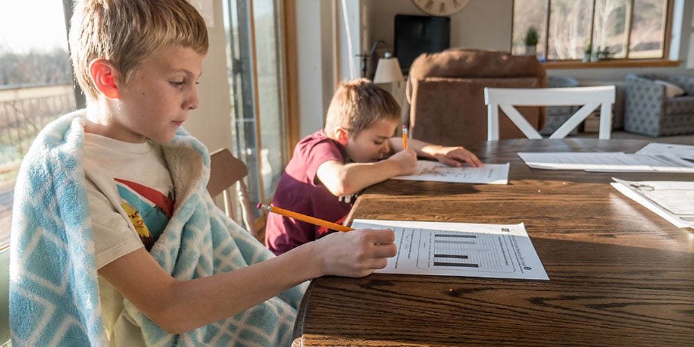 kids-sitting-at-table-doing-phonics-games