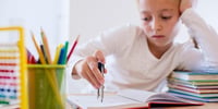 bored kid doing homework