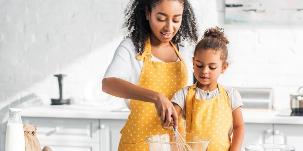 child and mother cooking in the kitchen