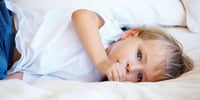 child lying in bed