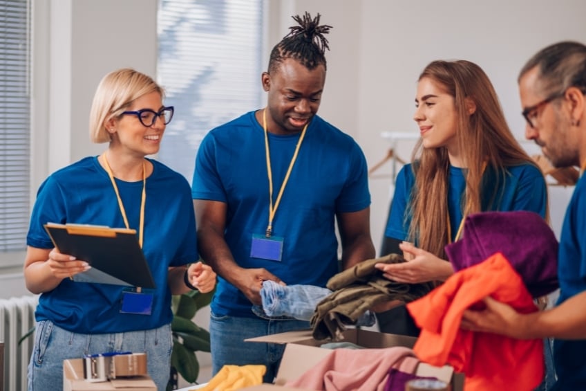 Retail staff planning and organising clothing for the shop