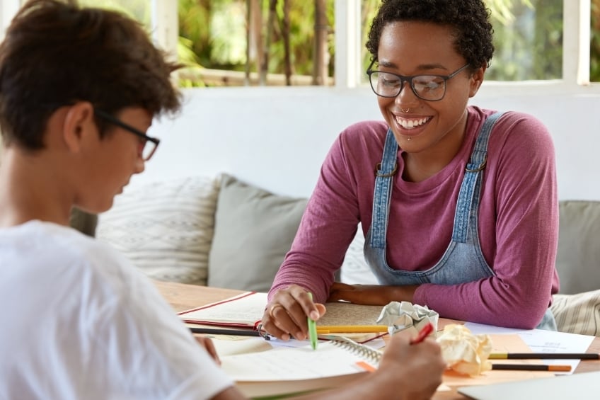a teenager and his tutor during a back to school catch up lesson