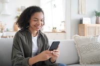 Happy young woman using a mobile app