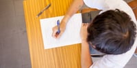 child taking exam at desk