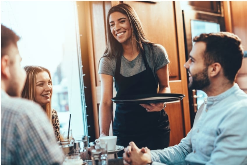 happy waitress serving a table