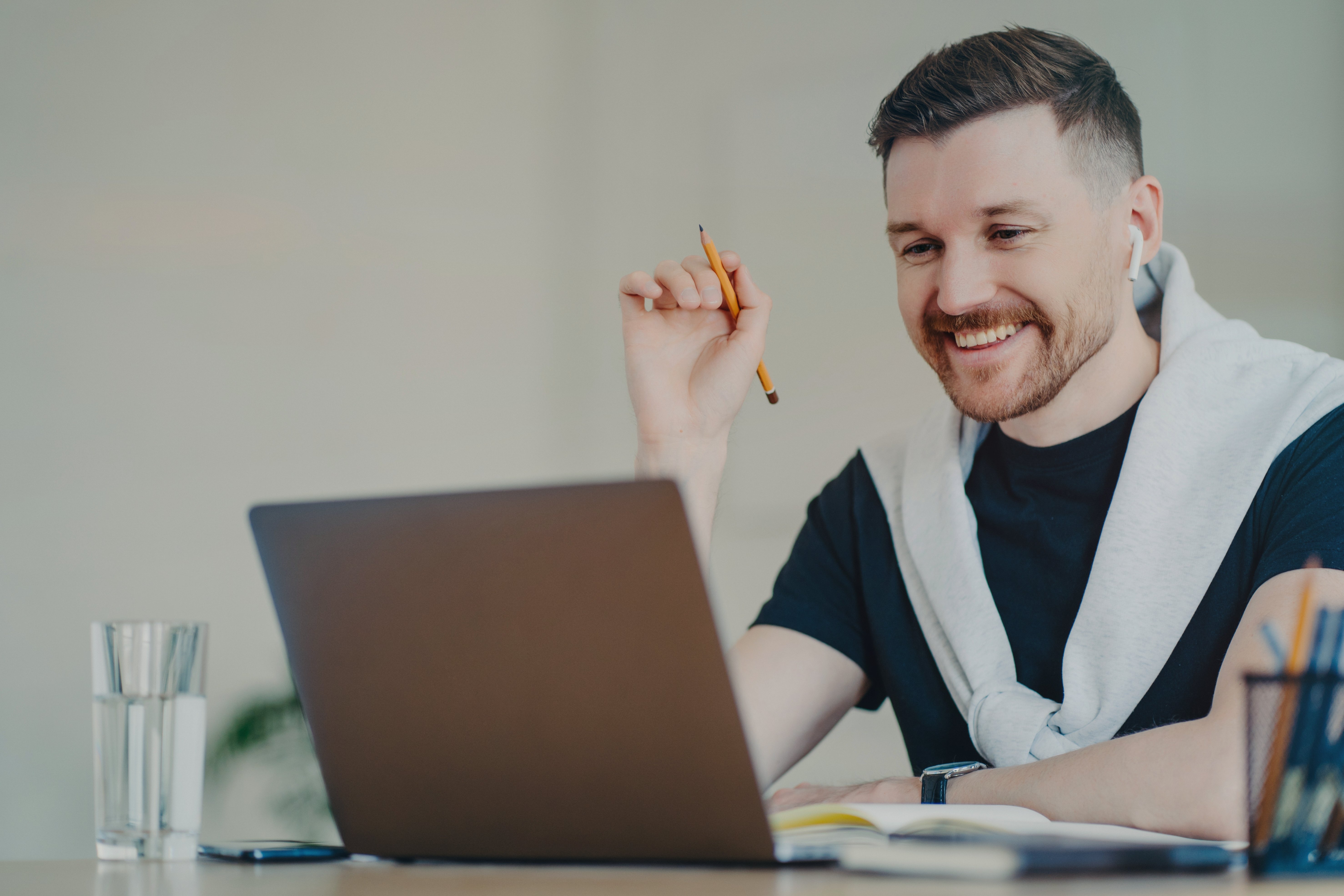 happy-bearded-man-prepares-paper-course-work-works-2025-03-08-14-46-54-utc