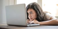 girl looking at computer