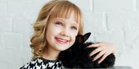 girl cuddling a cat