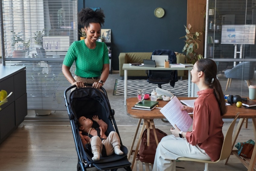 student-summer-job-as-a-nanny-pushing-a-stroller-during-a-home-visit