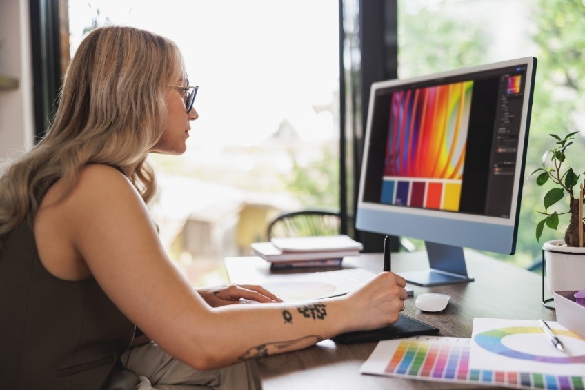 student-summer-job-doing-graphic-design-work-on-a-colourful-digital-monitor