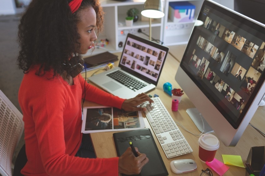 student-summer-job-editing-photos-on-dual-computer-monitors