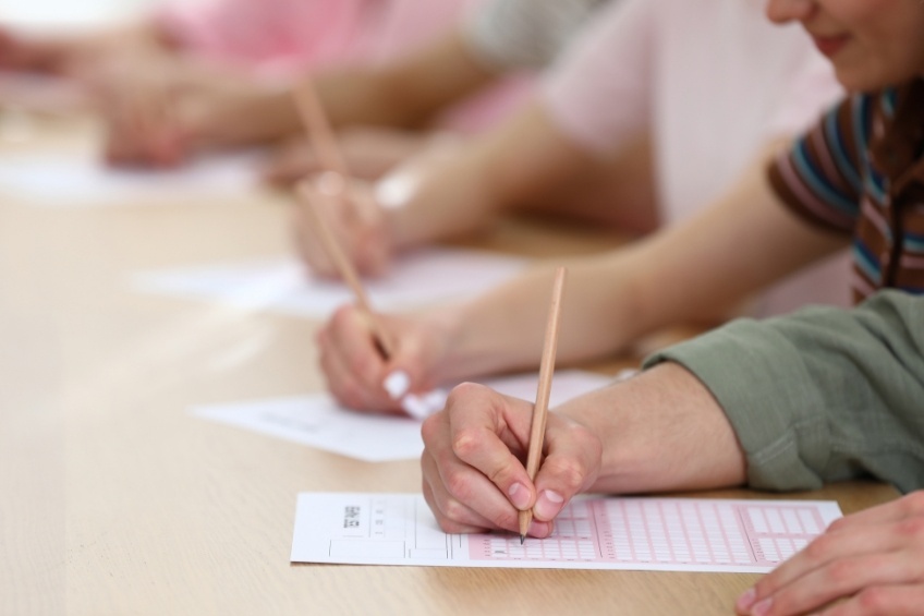 students-handwrite-a-level-exam-answer-sheets-together
