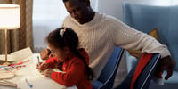 father homeschooling child