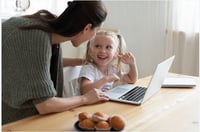 father working from home with toddler