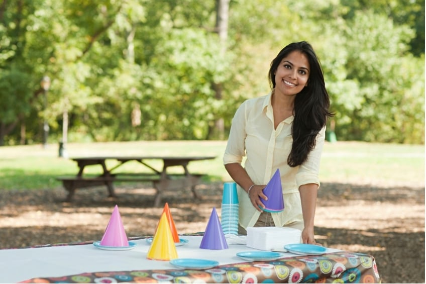 woman setting up a table for a school activity programme