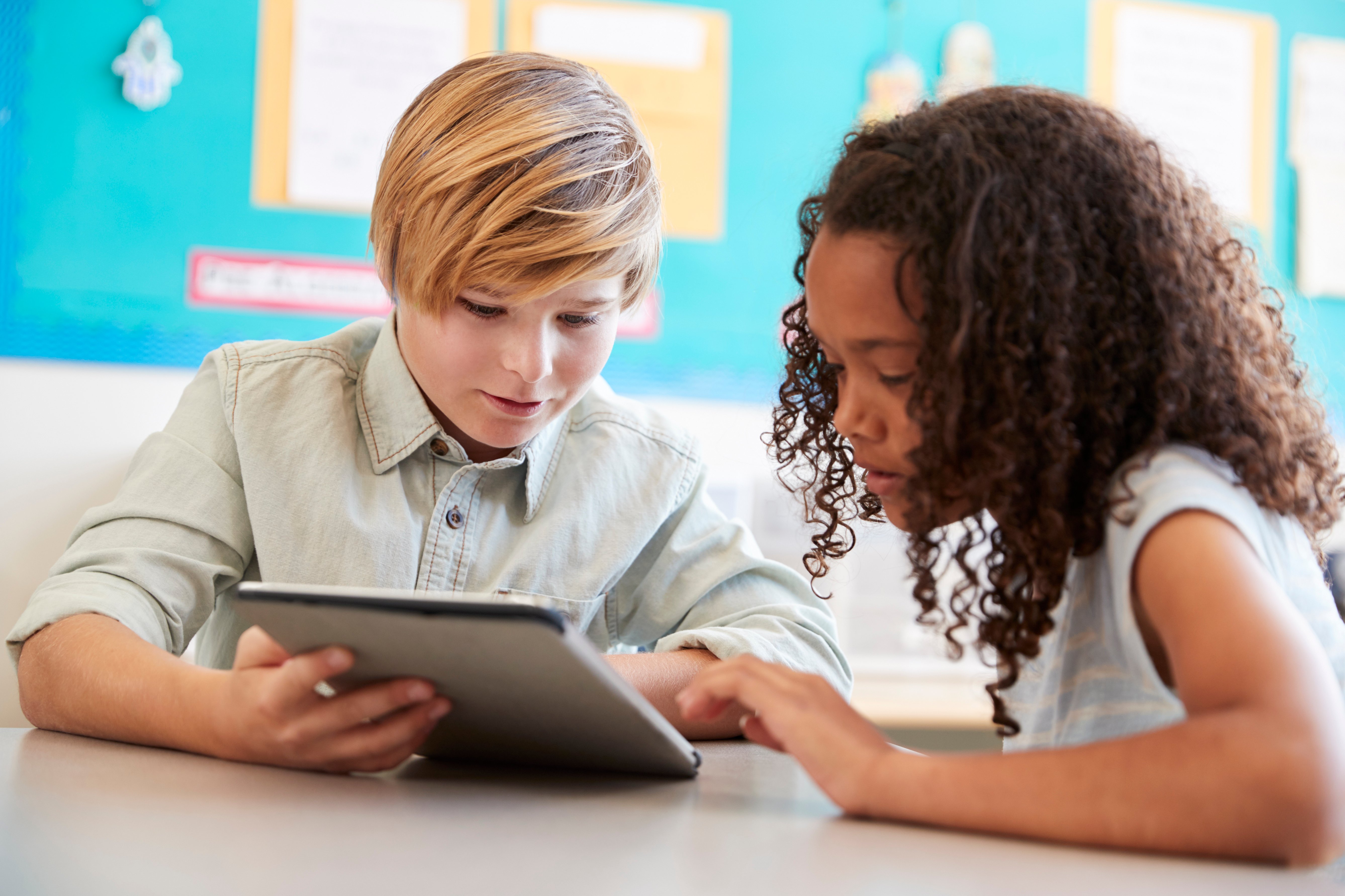 young-girl-and-boy-using-tablet-in-elementary-scho-2026-03-10-03-21-59-utc