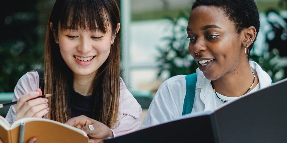 two girls reading a book