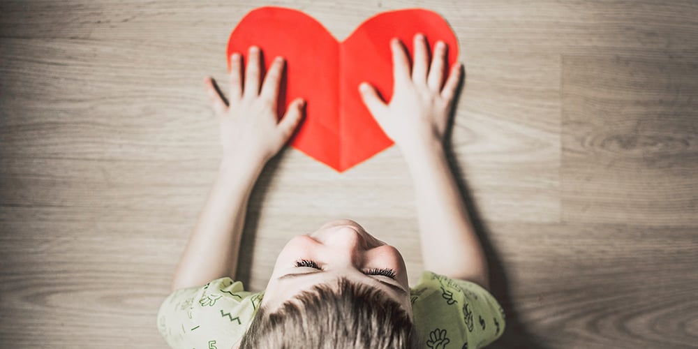 child holding a heart